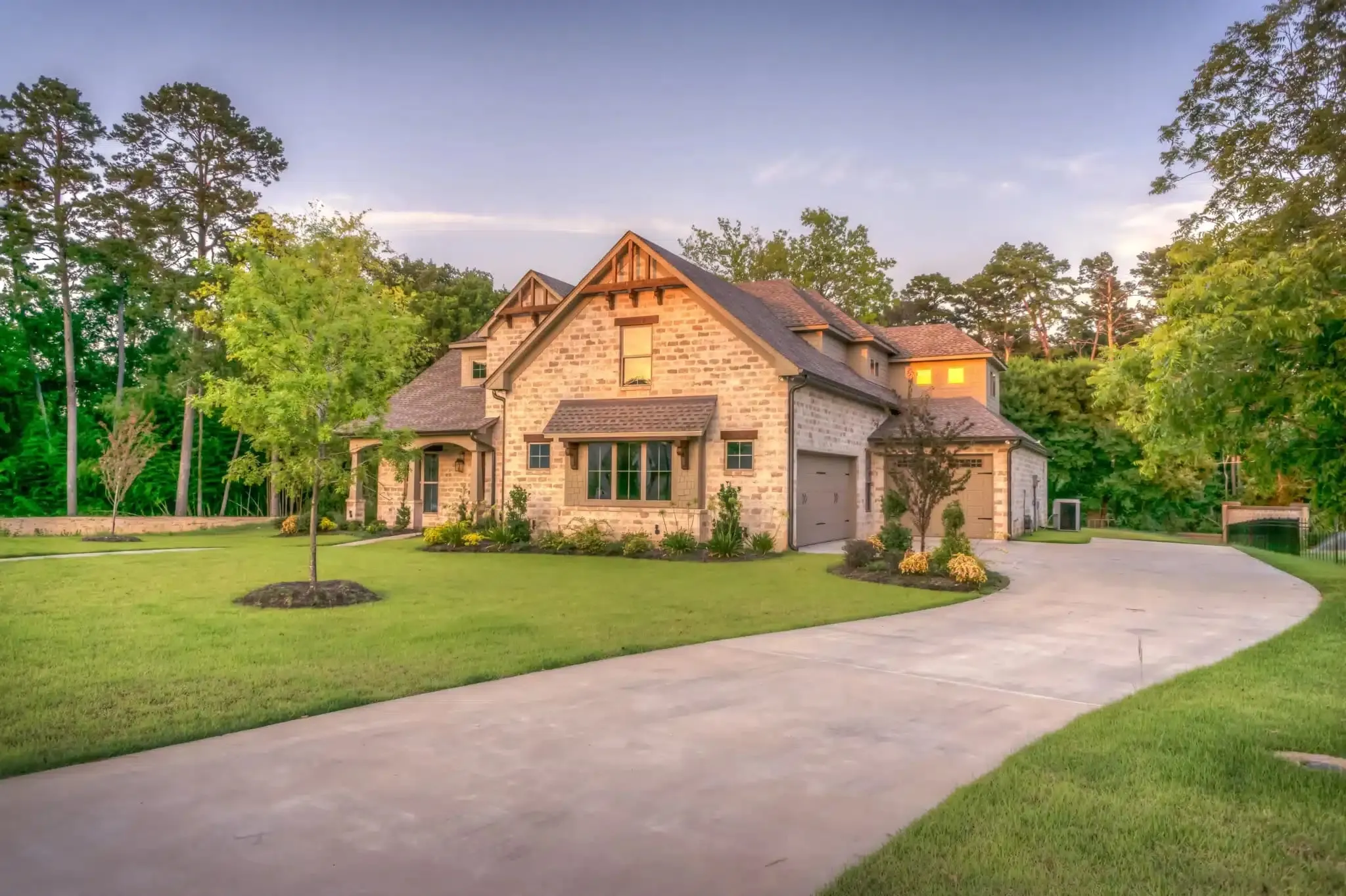 Stone and timber home at the end of a long curved driveway