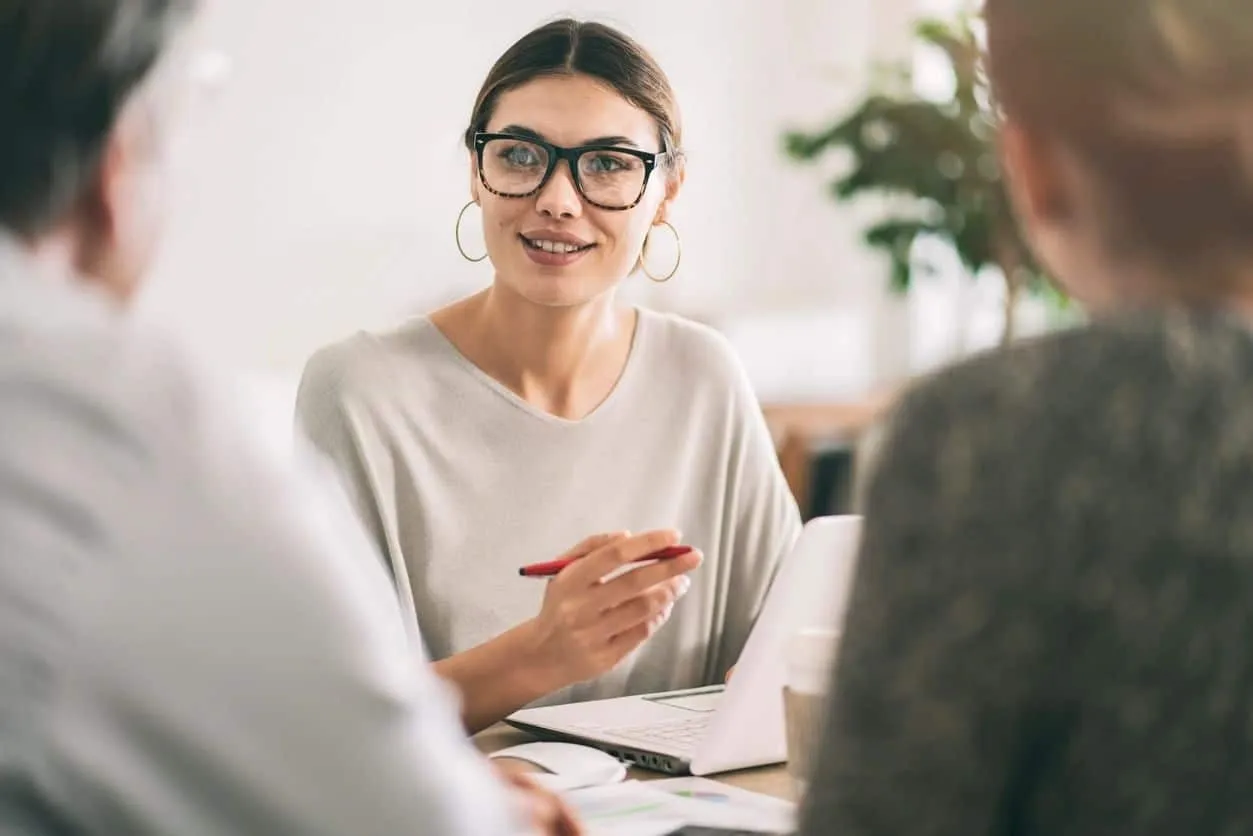 Real estate agent meeting with clients at a table