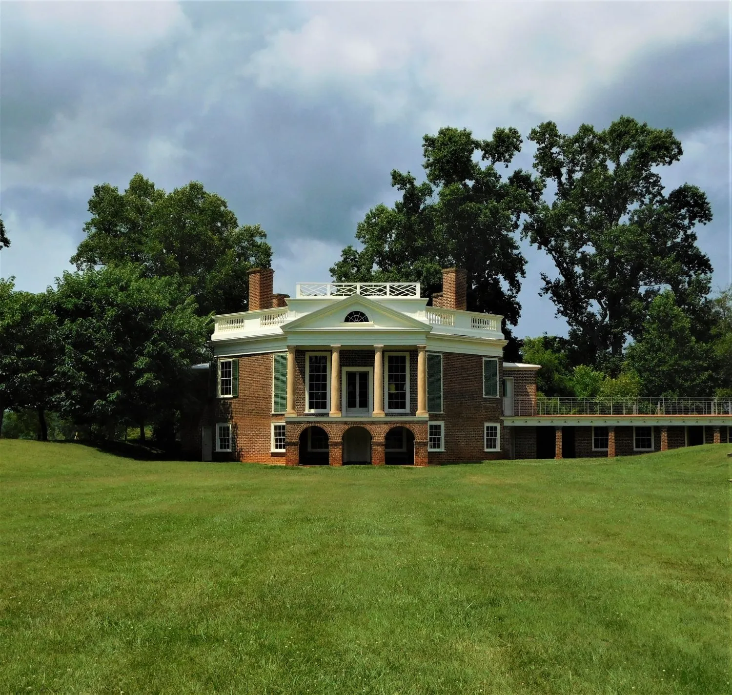 The south facade of Poplar Forest, with its white portico and columns above a sweeping lawn