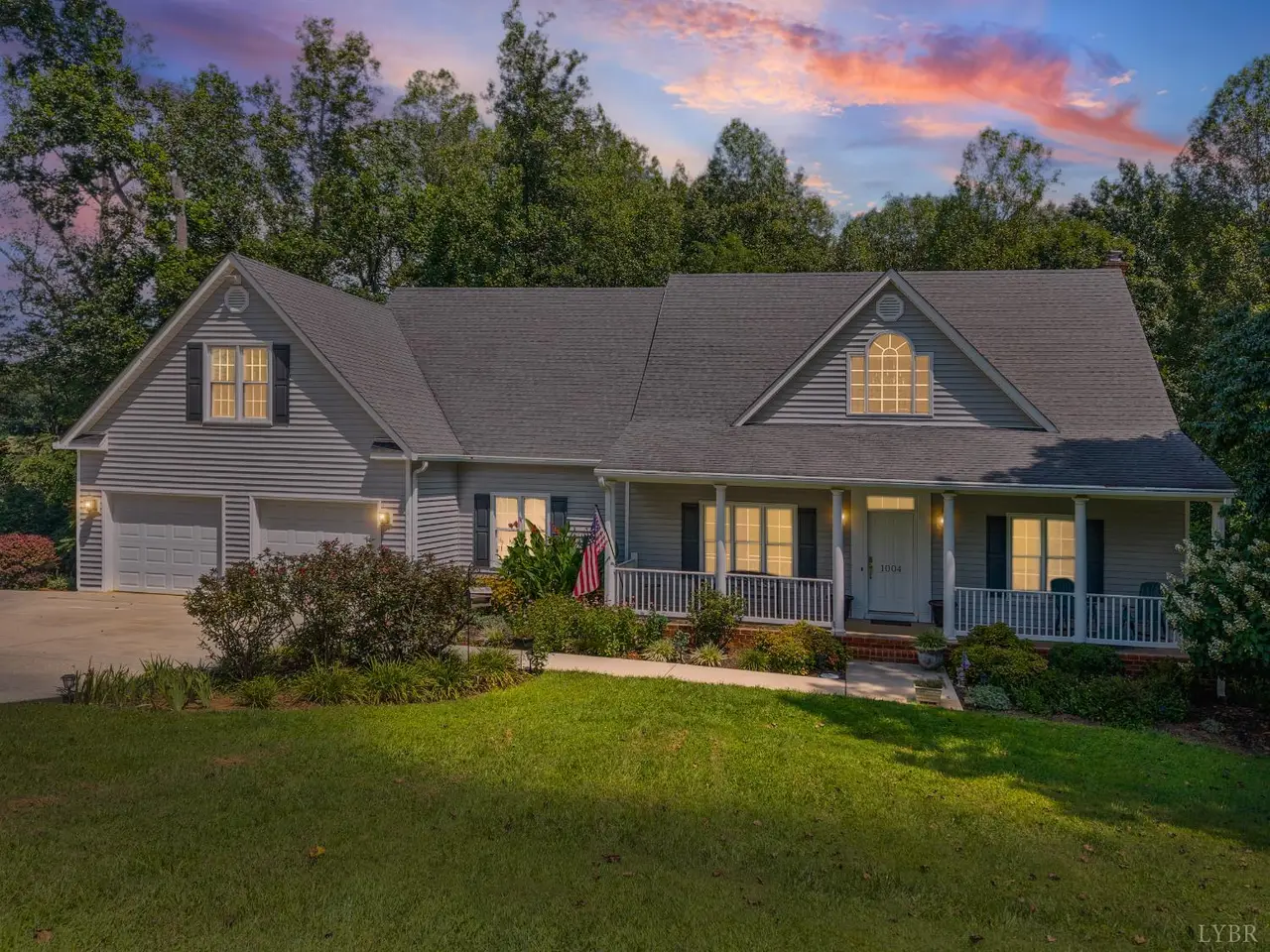 Front of the house with a covered front porch and garage at dusk at 1004 Wildbriar Place, Forest VA