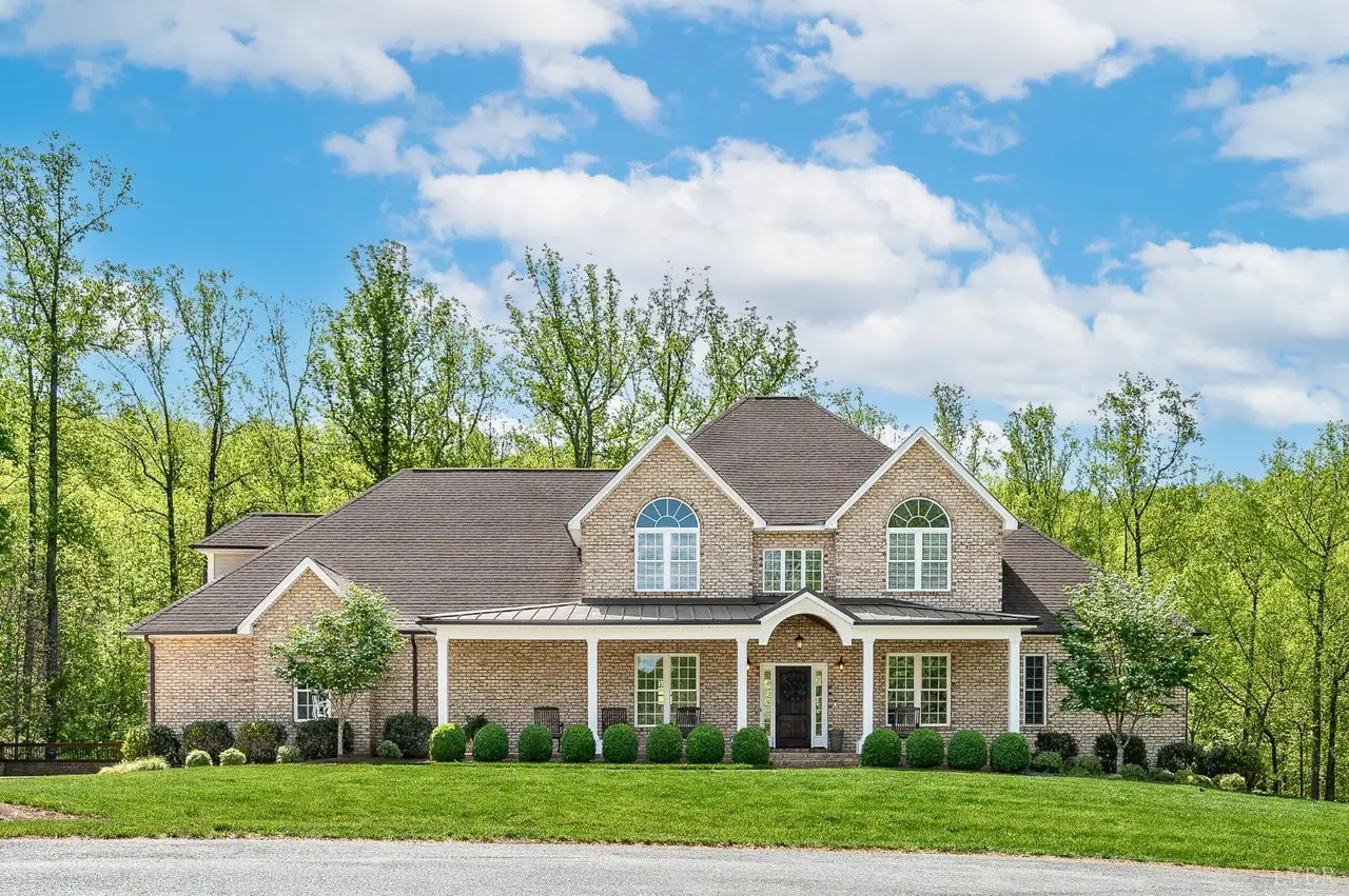 Front of the brick house with a covered front porch and arched windows at 1009 Val Ter Court, Forest VA