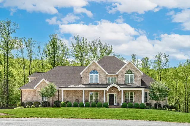 Front of the brick house with a covered front porch and arched windows at 1009 Val Ter Court, Forest VA