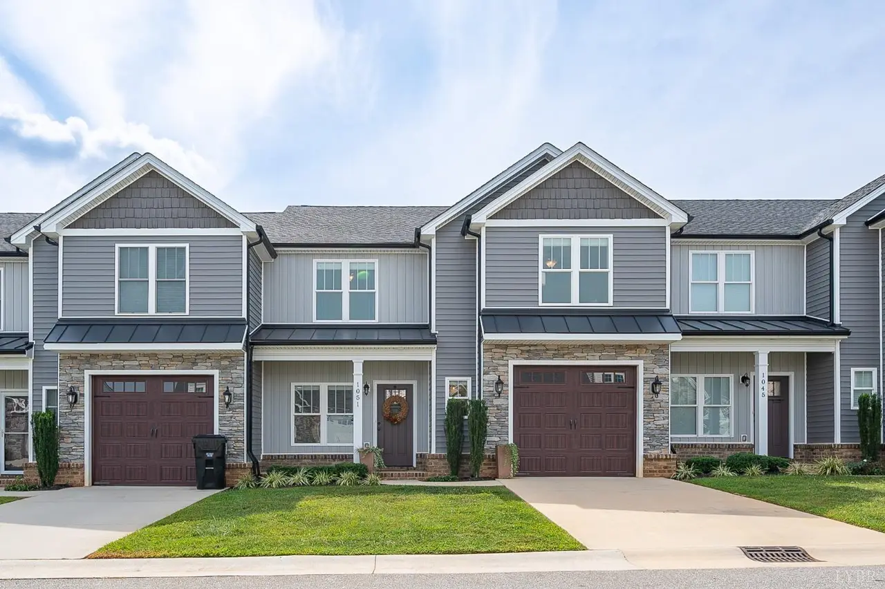 Front of the townhomes with gray siding and stone accents at 1051 Cobblestone Lane, Forest VA
