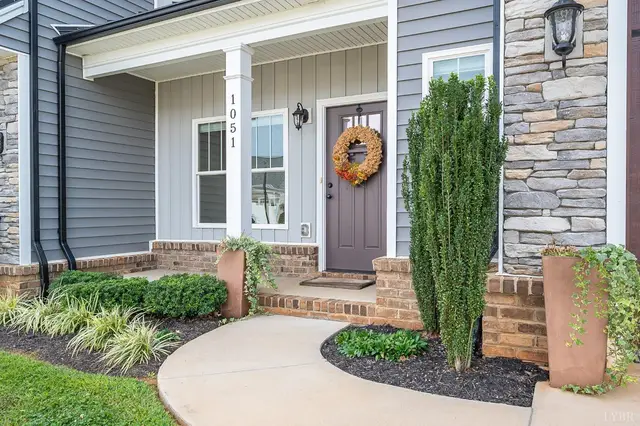 Front entry with a stone column and a wreath on the door at 1051 Cobblestone Lane, Forest VA