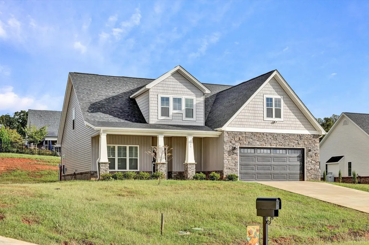 Front of the house with a covered porch and stone-front garage at 1059 Wild Fox Court, Lynchburg VA