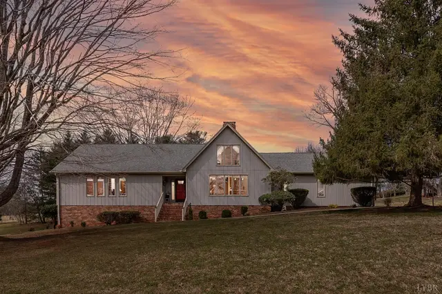 Front of the house with a brick foundation at sunset at 107 Hitching Post Lane, Forest VA