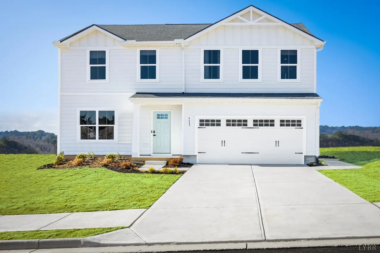 Front of the two-story house with white siding and a two-car garage at 108 Viking Lane, Forest VA