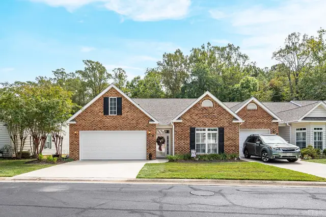 Front of the brick townhome with a garage at 109 Jonathan's Landing, Lynchburg VA