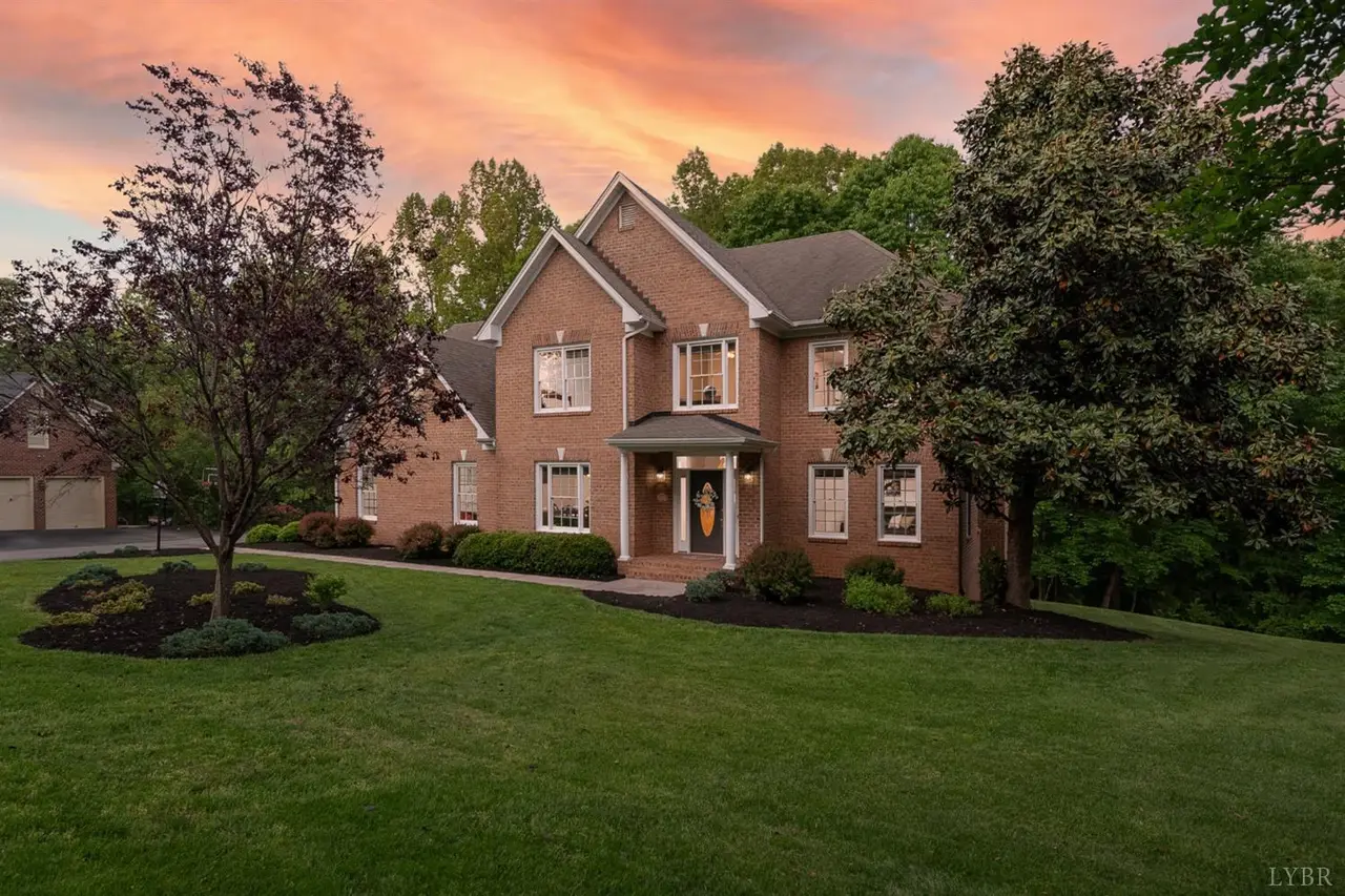 Front of the brick house with a landscaped lawn at sunset at 109 Lambeth Court, Lynchburg VA