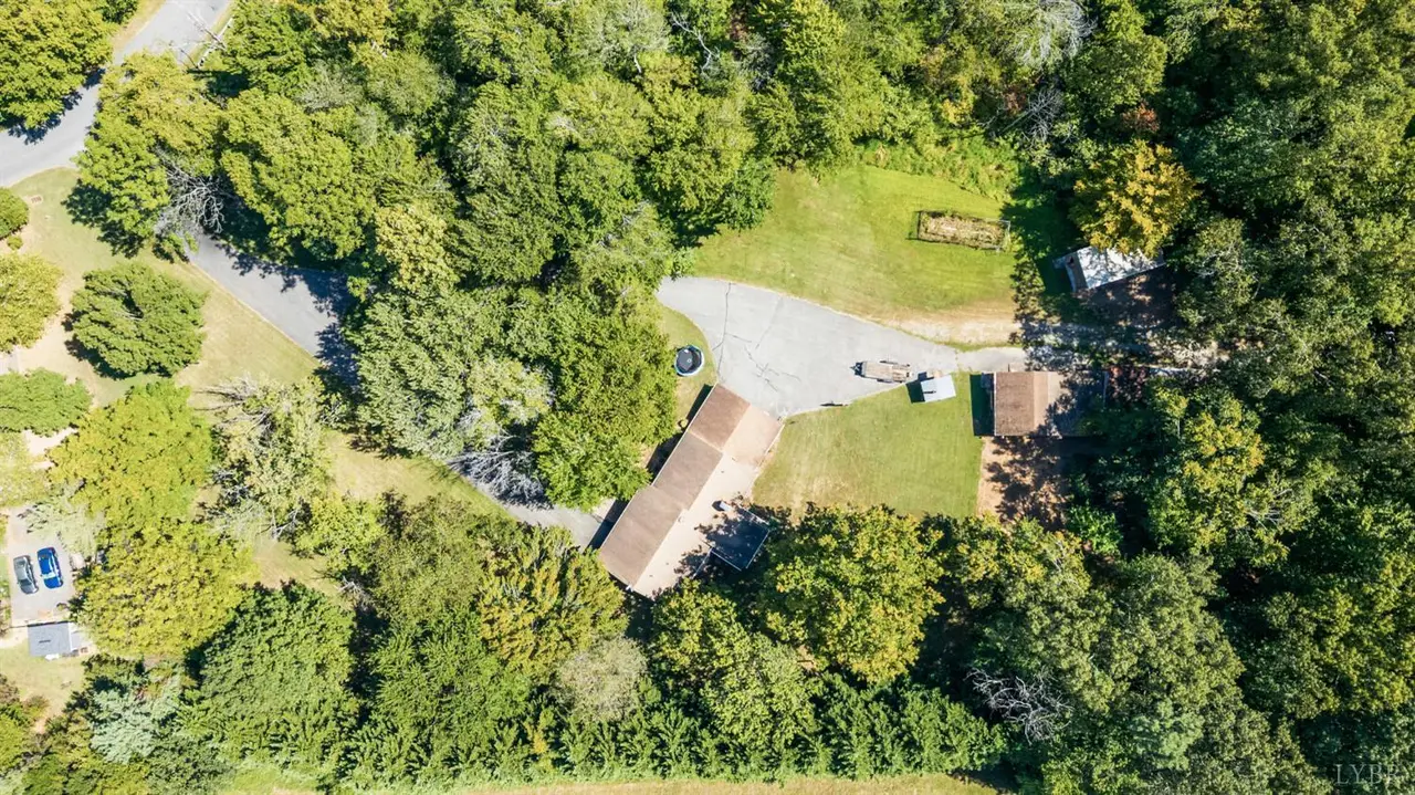 Aerial view of the house on a wooded lot at 1103 Moreview Drive, Lynchburg VA