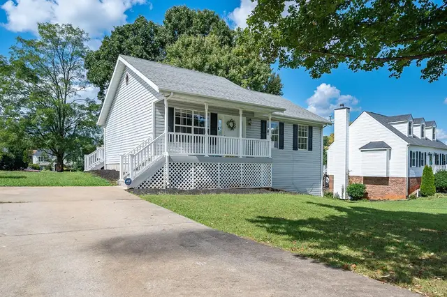Front of the house with a covered front porch and concrete driveway at 111 Willow Bend Drive, Lynchburg VA
