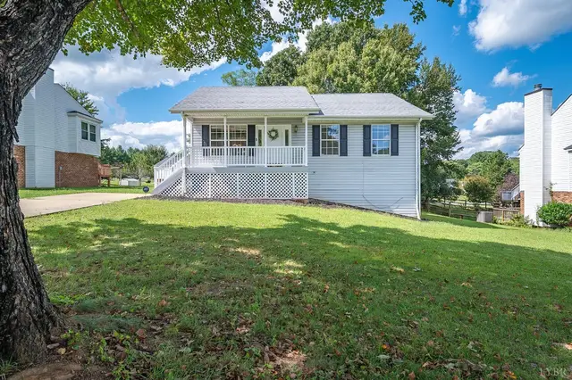 Front of the house with a covered porch and sloped lawn at 111 Willow Bend Drive, Lynchburg VA