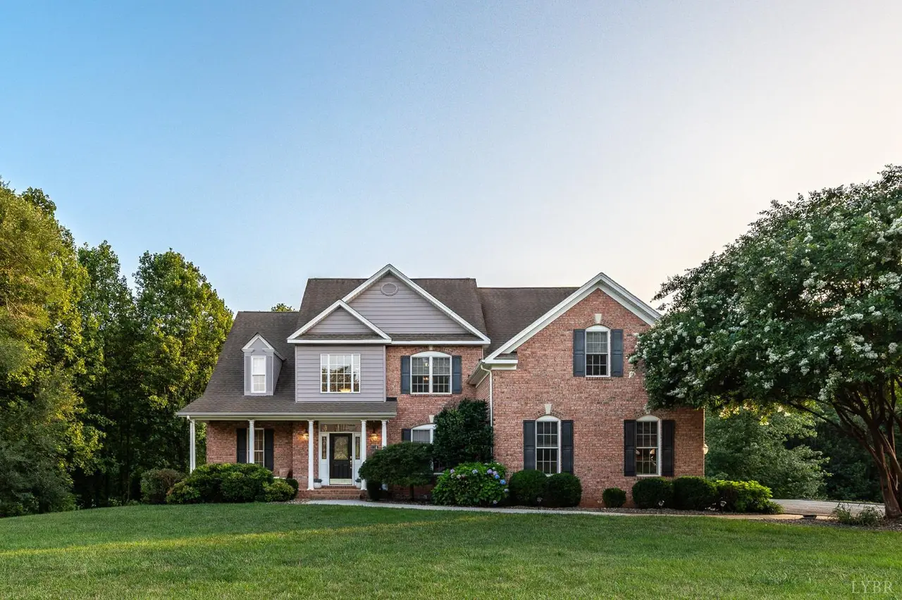 Front of the brick house with a covered porch and landscaped lawn at 1118 Jefferson Dr W, Forest VA
