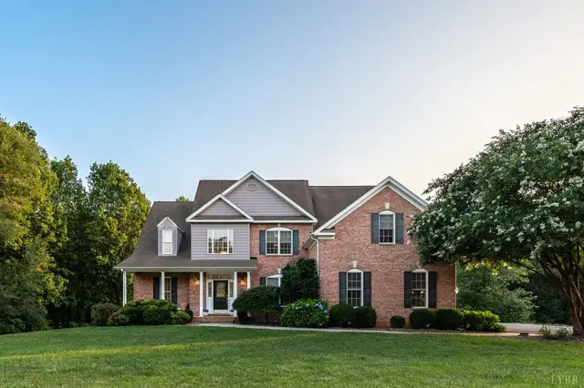 Front of the brick house with a covered porch and landscaped lawn at 1118 Jefferson Dr W, Forest VA