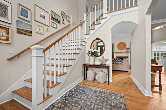 Entry hall with a white staircase and gallery wall at 1118 Jefferson Dr W, Forest VA