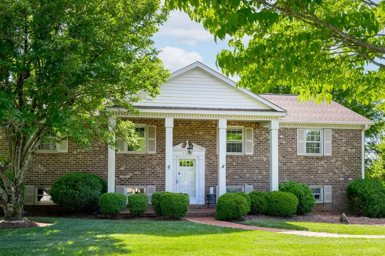 Front of the brick house with white columns and a front portico at 1121 Moreview Drive, Lynchburg VA