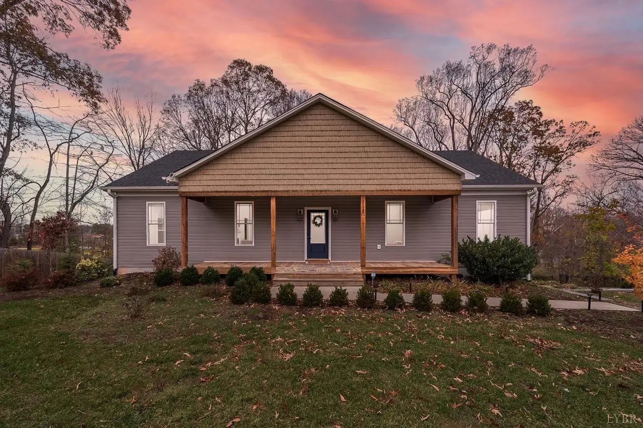 Front of the house at sunset with a covered front porch and wood posts at 117 Victor Drive, Lynchburg VA