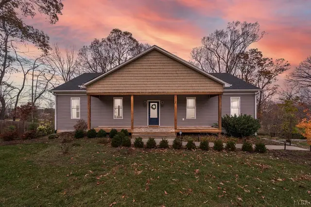 Front of the house at sunset with a covered front porch and wood posts at 117 Victor Drive, Lynchburg VA