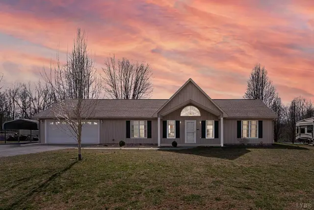 Front of the house, one-story with an attached garage at sunset at 1247 Navigation Point, Goodview VA