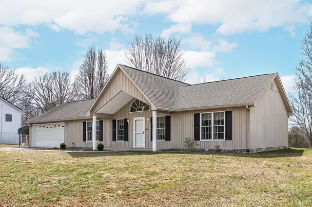 Front of the house, one-story with an arched gable window and attached garage at 1247 Navigation Point, Goodview VA