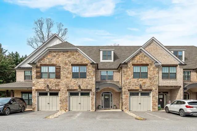 Front of the townhouses, stone and brick with single-car garages at 1249 Sleepy Oak Lane, Forest VA
