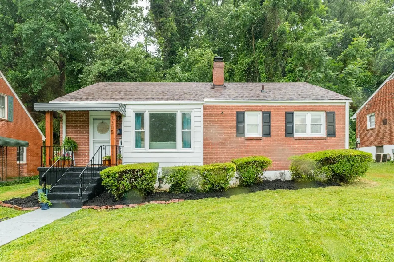Front of the house, brick ranch with white siding and a stoop with railings at 1305 Cherokee Avenue, Lynchburg VA