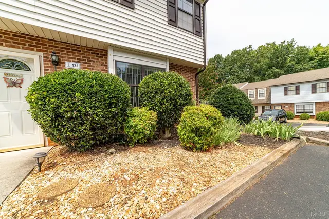 Front entry with landscaped shrubs beside the parking lot at 131 Cape Charles Square, Lynchburg VA