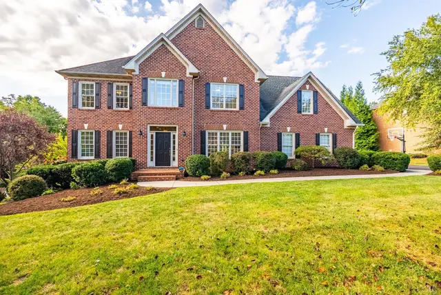Front of the house, two-story brick with black shutters and a green lawn at 134 Beacon Hill Place, Lynchburg VA