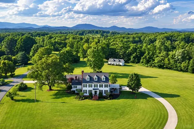 Aerial view of the house on a large lawn with mountains in the distance at 1351 Country Estates Drive, Lowry VA