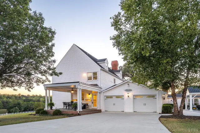 Side of the house with an attached two-car garage and a covered porch at 1351 Country Estates Drive, Lowry VA