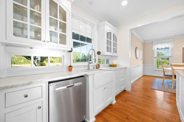 Kitchen sink under a window with glass-front cabinets at 1351 Country Estates Drive, Lowry VA