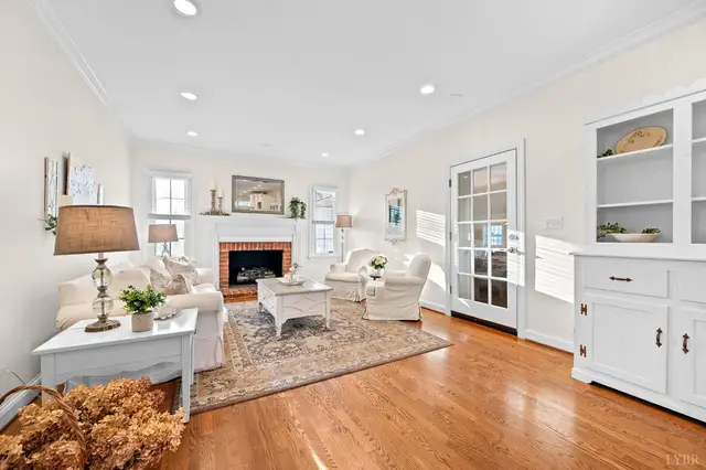 Living room with a brick fireplace, white seating and a glass door at 1351 Country Estates Drive, Lowry VA