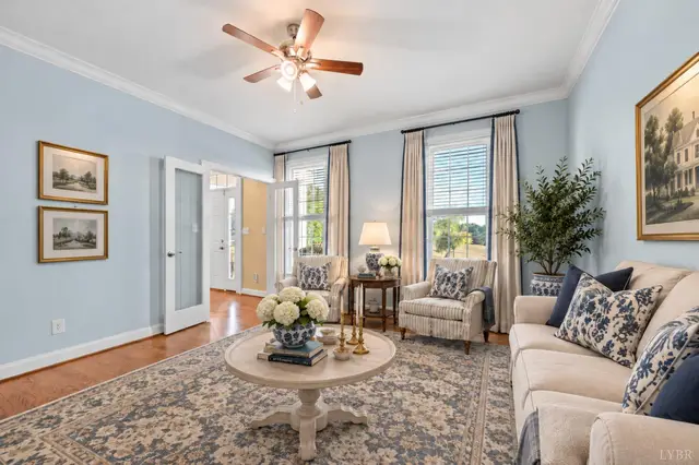 Sitting room with light blue walls, a ceiling fan and glass French doors at 1351 Country Estates Drive, Lowry VA