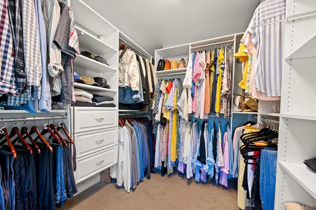 Walk-in closet with hanging rods and built-in drawers at 1351 Country Estates Drive, Lowry VA