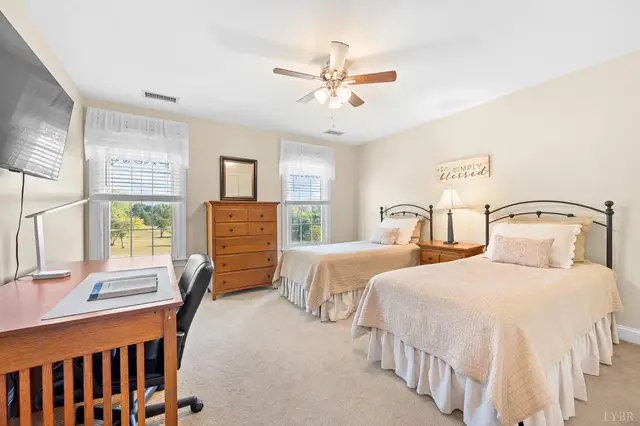 Bedroom with two twin beds and a wood desk at 1351 Country Estates Drive, Lowry VA