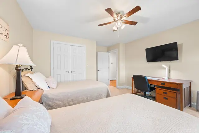 Bedroom with a double closet, a desk and a wall mounted TV at 1351 Country Estates Drive, Lowry VA