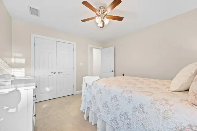 Bedroom with a double closet and a ceiling fan at 1351 Country Estates Drive, Lowry VA