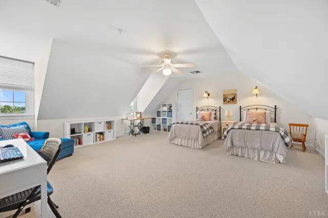 Bedroom with sloped ceilings, two twin beds and built-in cubbies at 1351 Country Estates Drive, Lowry VA