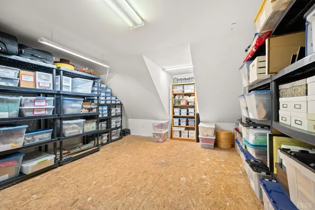 Attic storage room with metal shelving and plastic bins at 1351 Country Estates Drive, Lowry VA