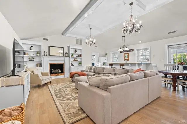 Family room with a vaulted ceiling, chandeliers and a sectional sofa at 1351 Country Estates Drive, Lowry VA