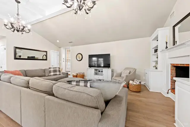 Family room with a brick fireplace, sectional sofa and TV at 1351 Country Estates Drive, Lowry VA