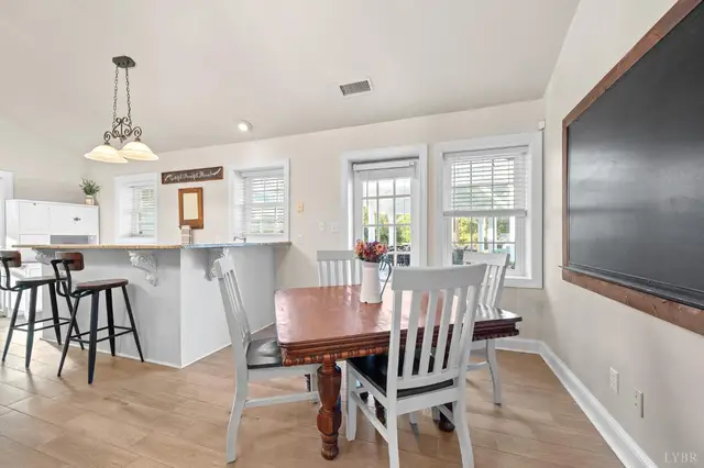 Dining area with a wood table, pendant light and a breakfast bar at 1351 Country Estates Drive, Lowry VA