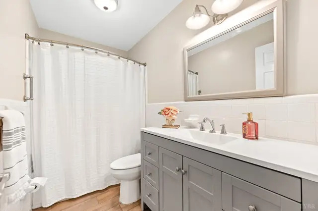 Bathroom with a gray vanity and a white shower curtain at 1351 Country Estates Drive, Lowry VA