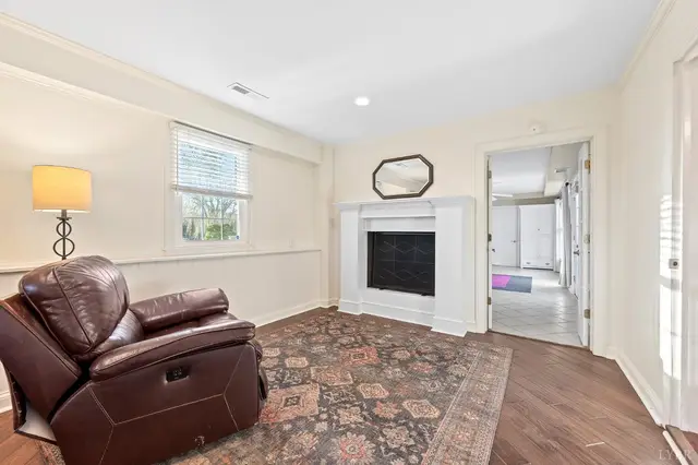 Sitting room with a white fireplace and a leather recliner at 1351 Country Estates Drive, Lowry VA