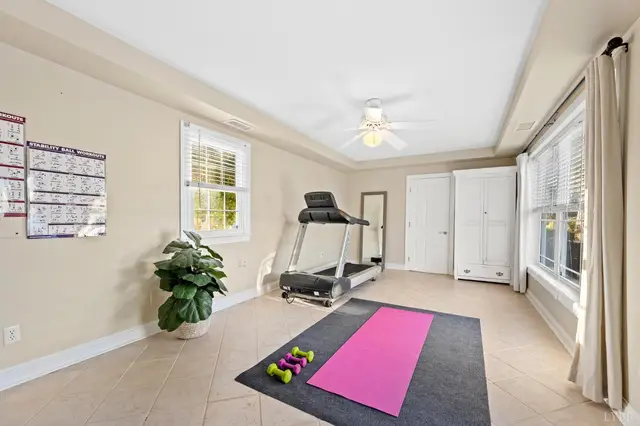 Exercise room with a treadmill, ceiling fan and tile floor at 1351 Country Estates Drive, Lowry VA