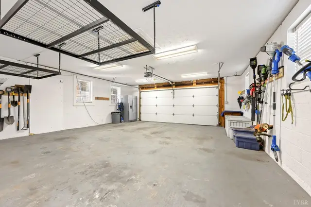 Garage with overhead storage racks and wall mounted tools at 1351 Country Estates Drive, Lowry VA
