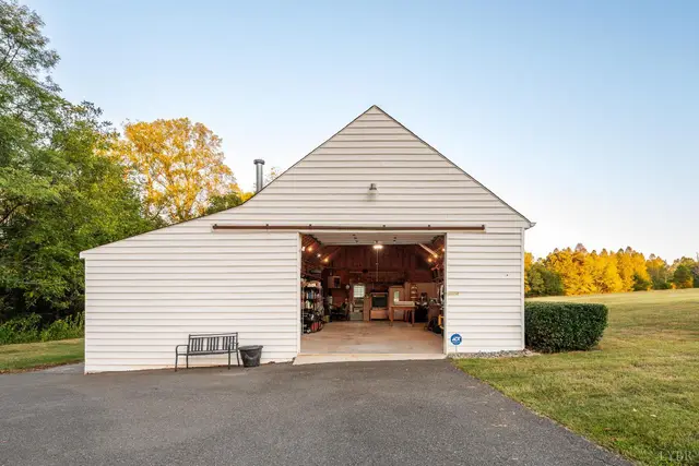 Detached garage with an open door and a workshop inside at 1351 Country Estates Drive, Lowry VA