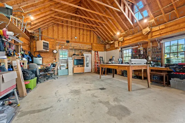 Workshop with a workbench, wood rafters and windows at 1351 Country Estates Drive, Lowry VA