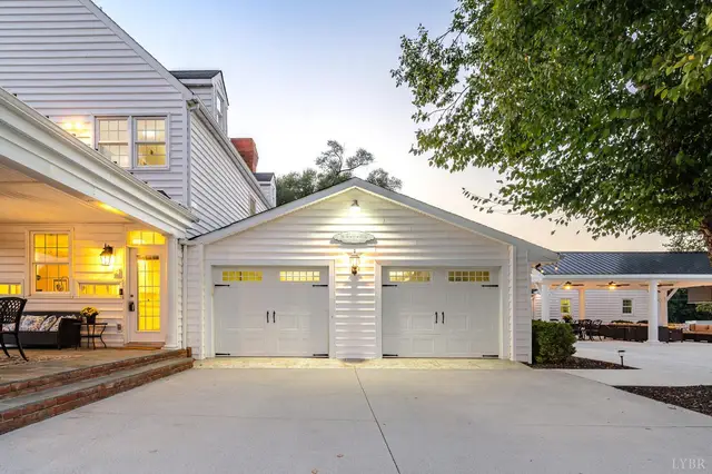 Attached two-car garage with white doors and a concrete driveway at 1351 Country Estates Drive, Lowry VA