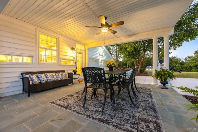 Back porch with a bench and dining table on flagstone at 1351 Country Estates Drive, Lowry VA